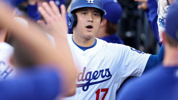 LOS ANGELES, CALIFORNIA - OCTOBER 20:  Shohei Ohtani #17 of the Los Angeles Dodgers is congratulated by teammates in the dugout after scoring on a double by Tommy Edman #25 during the 1st inning of Game Six of the National League Championship Series against the New York Mets at Dodger Stadium on October 20, 2024 in Los Angeles, California. (Photo by Sean M. Haffey/Getty Images)